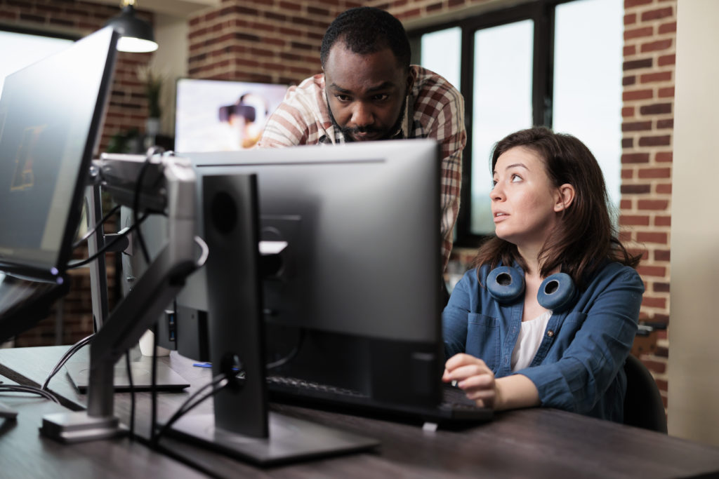 confident man pointing out mistakes in design blueprint while having conversation with colleague. confident man pointing out mistakes in design blueprint while having conversation with colleague.